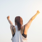 woman lifting both hands